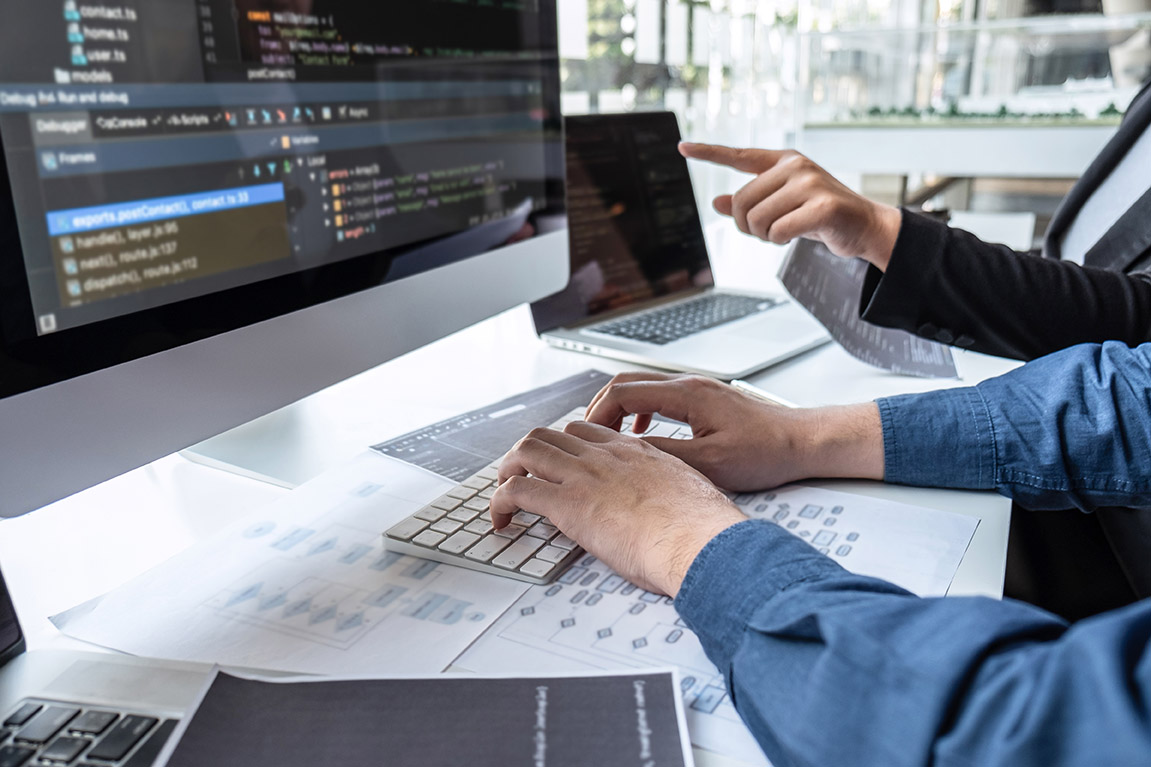 Close up of developer working on his computer coding software